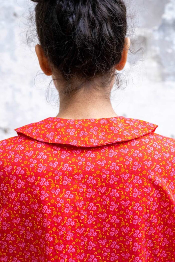 model wearing round collar shirt sula long sleeved flower print shirt