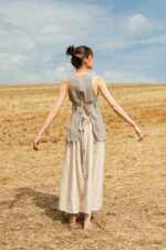 model wearing apron blouse sula Open back top with ties