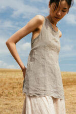 model wearing apron blouse sula Open back top with ties