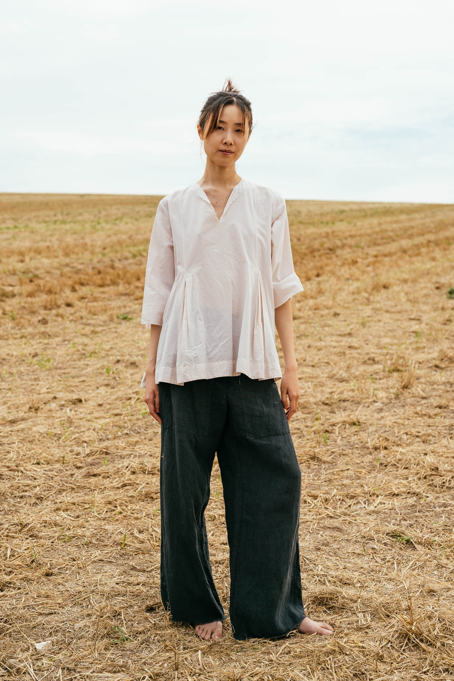 double pleat top cambric and flare pants linen front model wearing double pleat top sula Cotton top with pleats