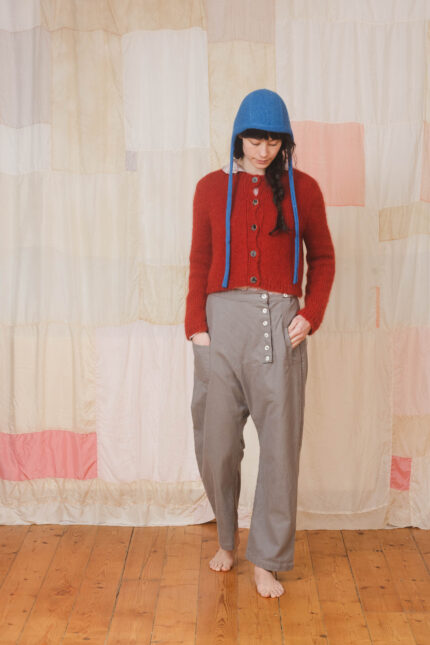 model wearing tin pants sula Slouchy side button pants and nickel cardi and bonnett