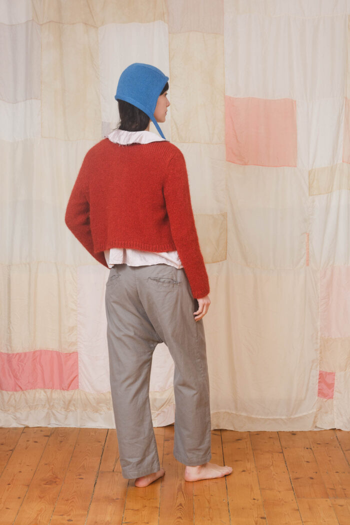 model wearing tin pants sula Slouchy side button pants and nickel cardi and bonnett