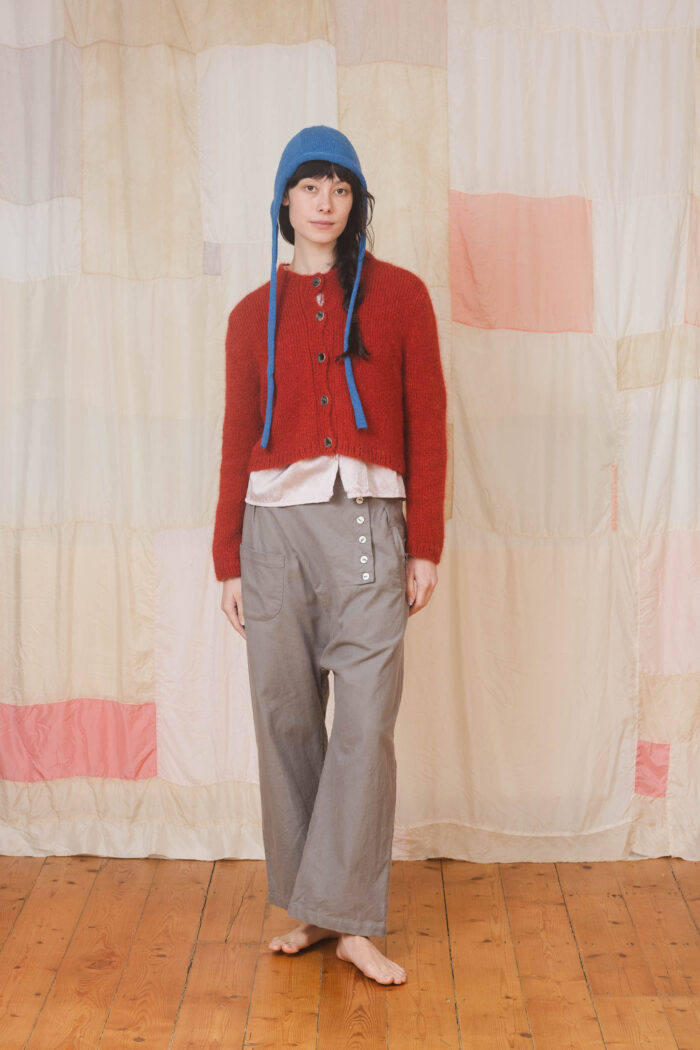 model wearing tin pants sula Slouchy side button pants and nickel cardi and bonnett
