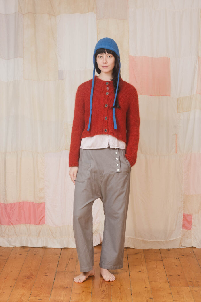 model wearing tin pants sula Slouchy side button pants and nickel cardi and bonnett