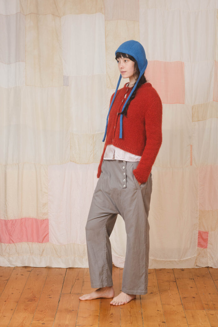 model wearing tin pants sula Slouchy side button pants and nickel cardi and bonnett