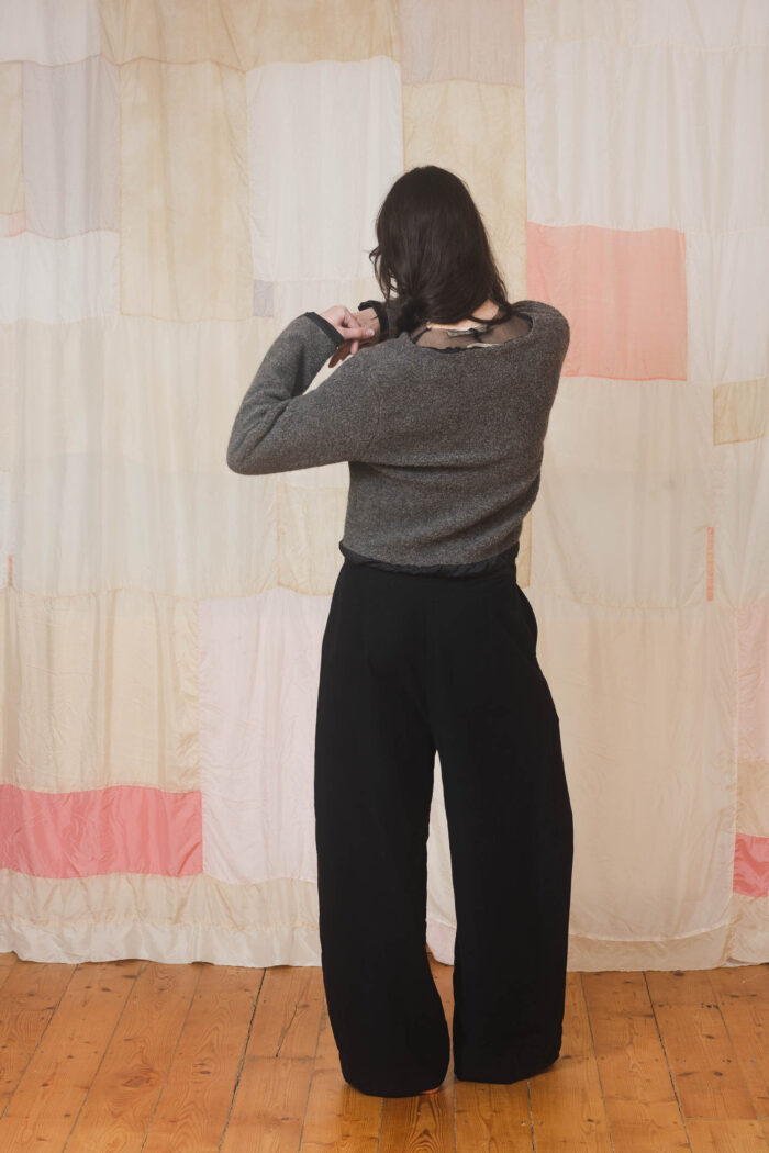 model wearing stornoway sweater sula Fluffy v-neck sweater and tailored pants