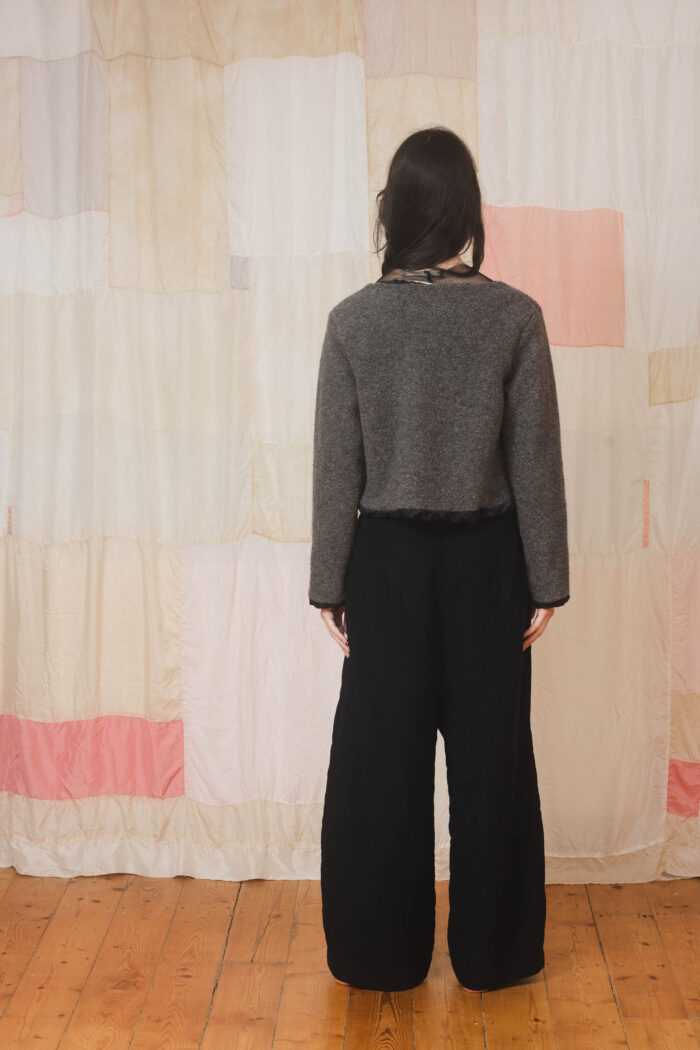 model wearing stornoway sweater sula Fluffy v-neck sweater and tailored pants