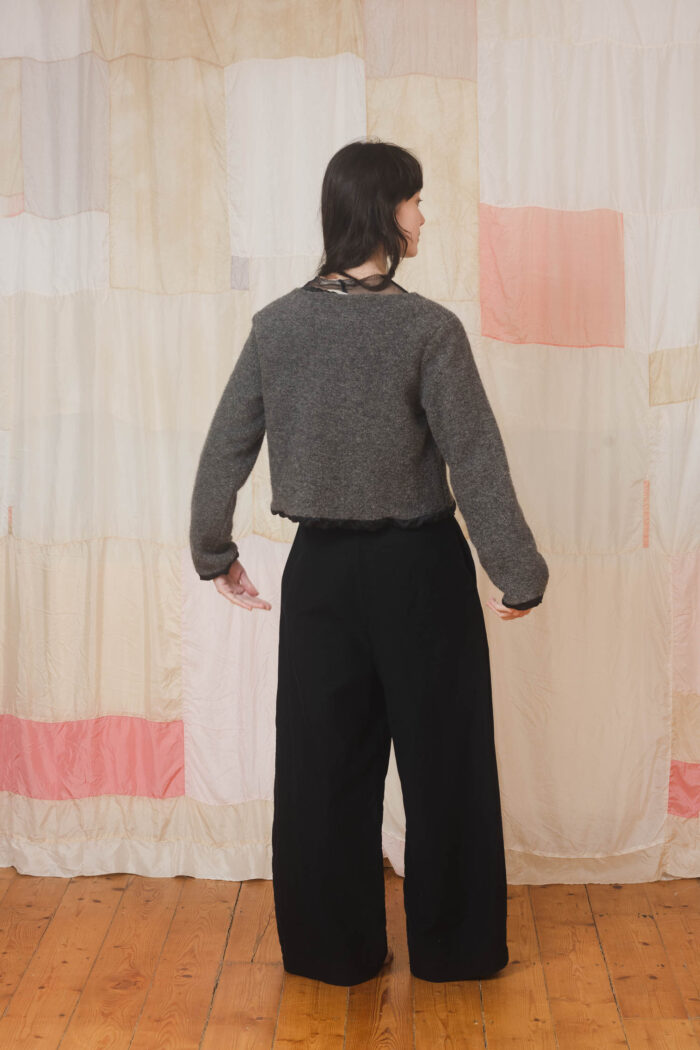model wearing stornoway sweater sula Fluffy v-neck sweater and tailored pants