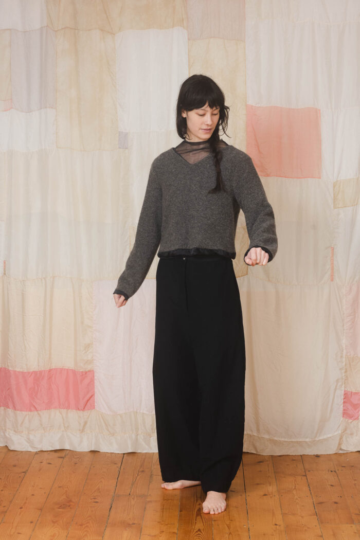 model wearing stornoway sweater sula Fluffy v-neck sweater and tailored pants