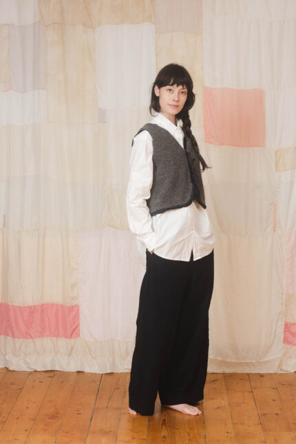 model wearing fluffy tie vest sula Fluffy body warmer and tailored pants