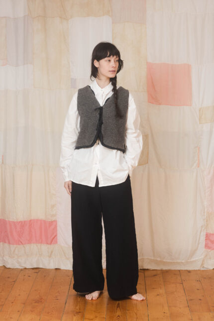 model wearing fluffy tie vest sula Fluffy body warmer and tailored pants