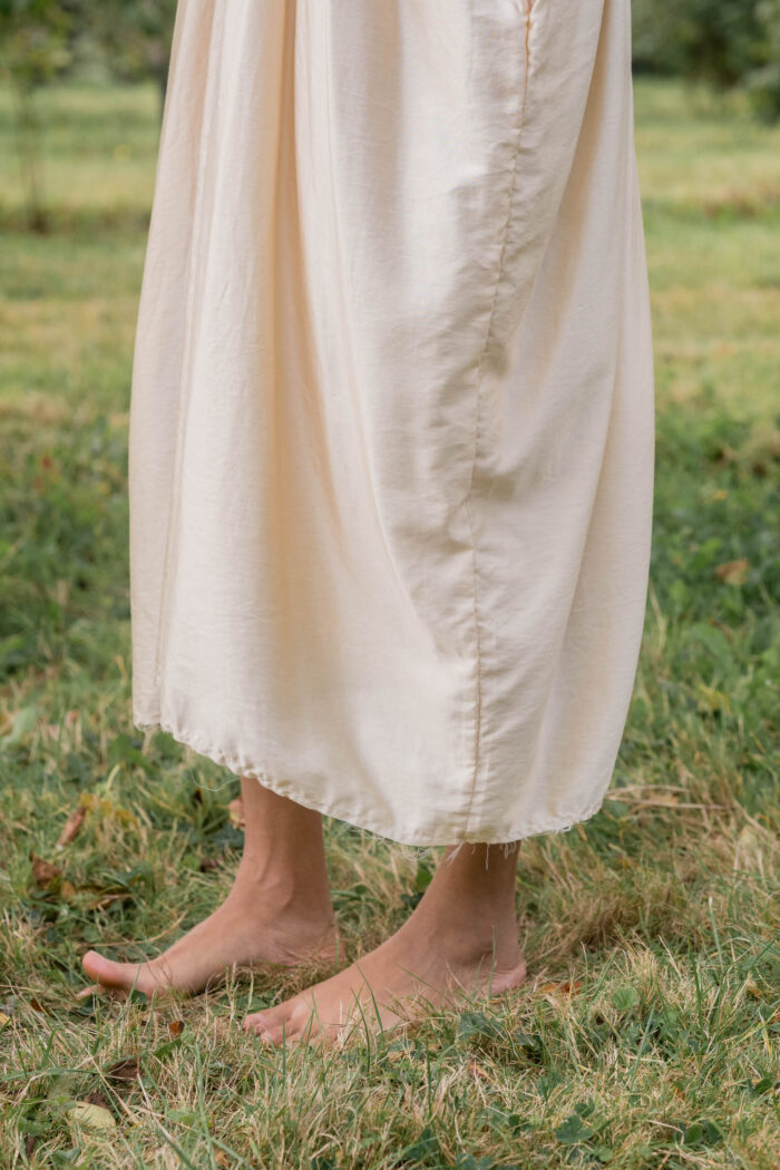 model wearing asymmetric moonbeam dress sula silk gathered dress