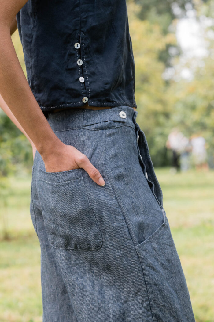 model wearing hem pants denim sula high waisted denim pants and corset top