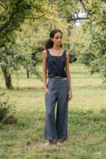 model wearing hem pants denim sula high waisted denim pants and corset top