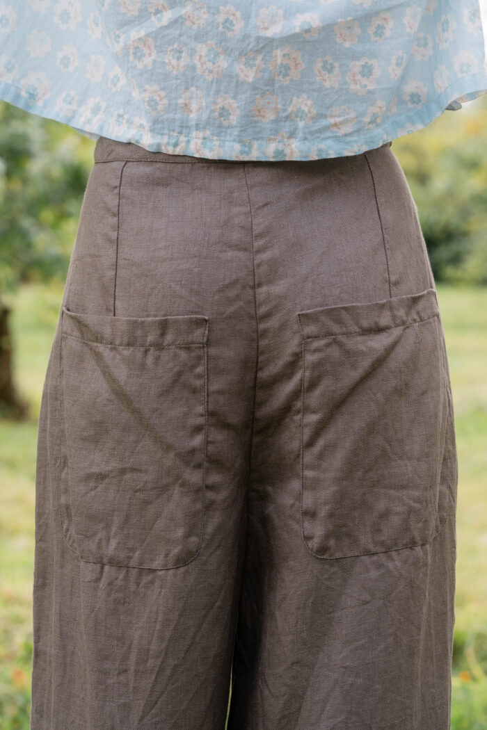 model wearing tailored line pants linen sula linen barrel leg trousers