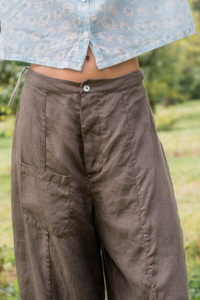 model wearing tailored line pants linen sula linen barrel leg trousers