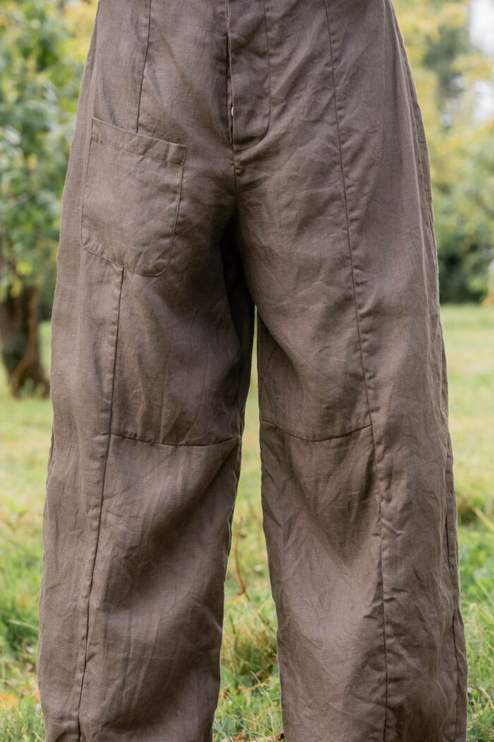 model wearing tailored line pants linen sula linen barrel leg trousers