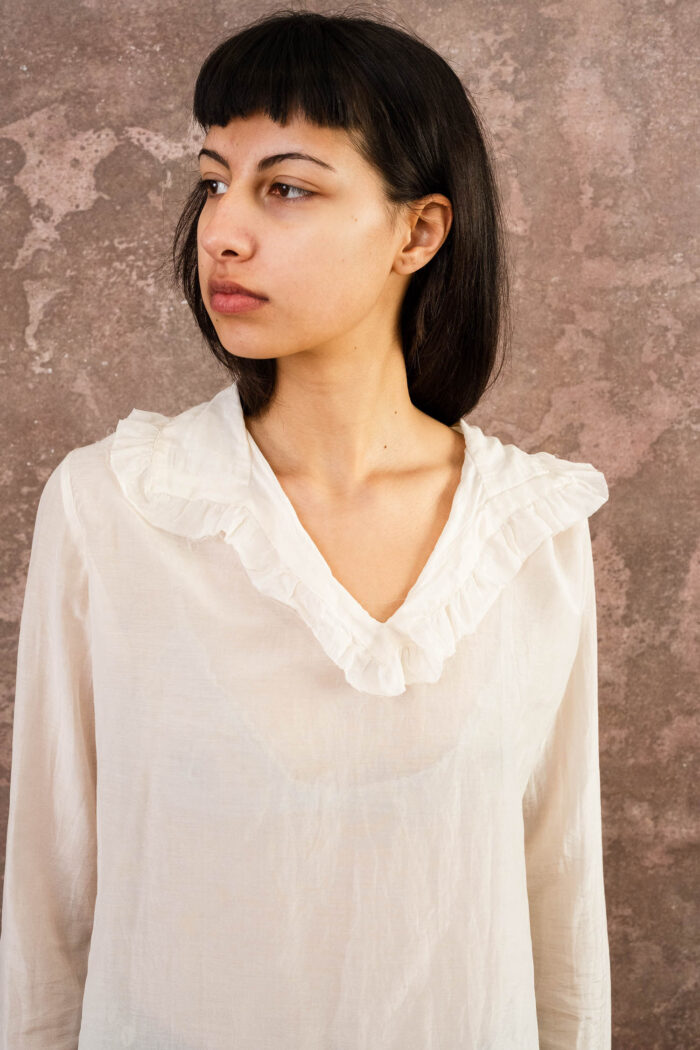 model wearing frill blouse sula blouse with frill collar