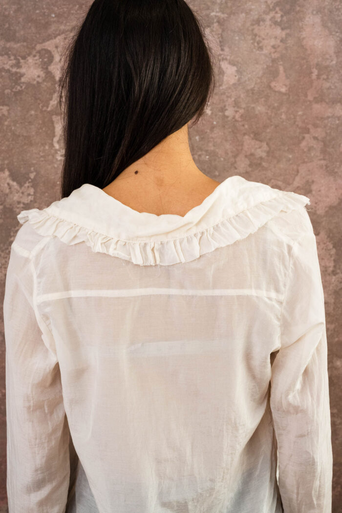 model wearing frill blouse sula blouse with frill collar