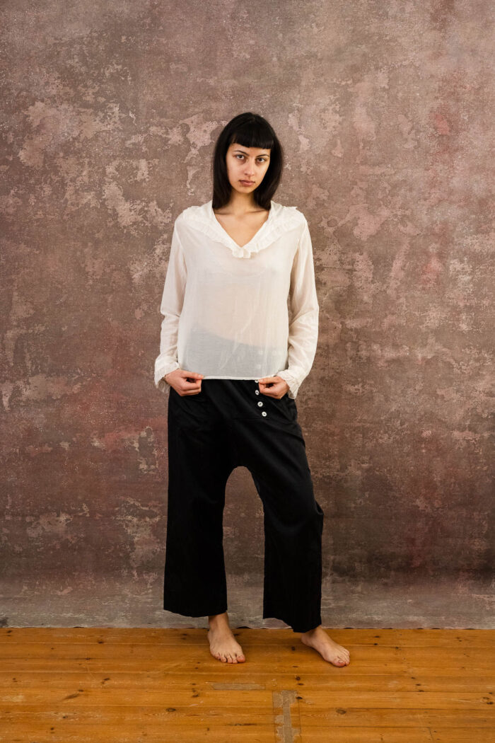 model wearing frill blouse sula blouse with frill collar