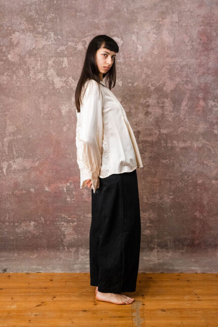 model wearing pleat shirt sula silk shirt with pleats