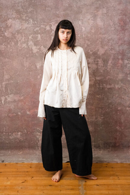 model wearing pleat shirt sula silk shirt with pleats